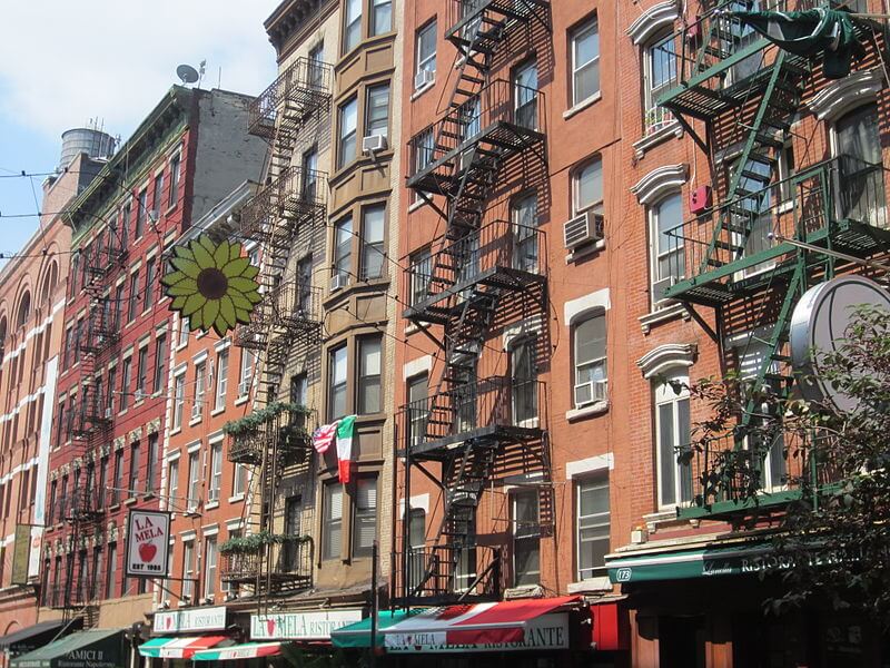 Colorful awnings beckon visitors to stop in for a cannoli or try a slice of pizza as they stroll through Little Italy.