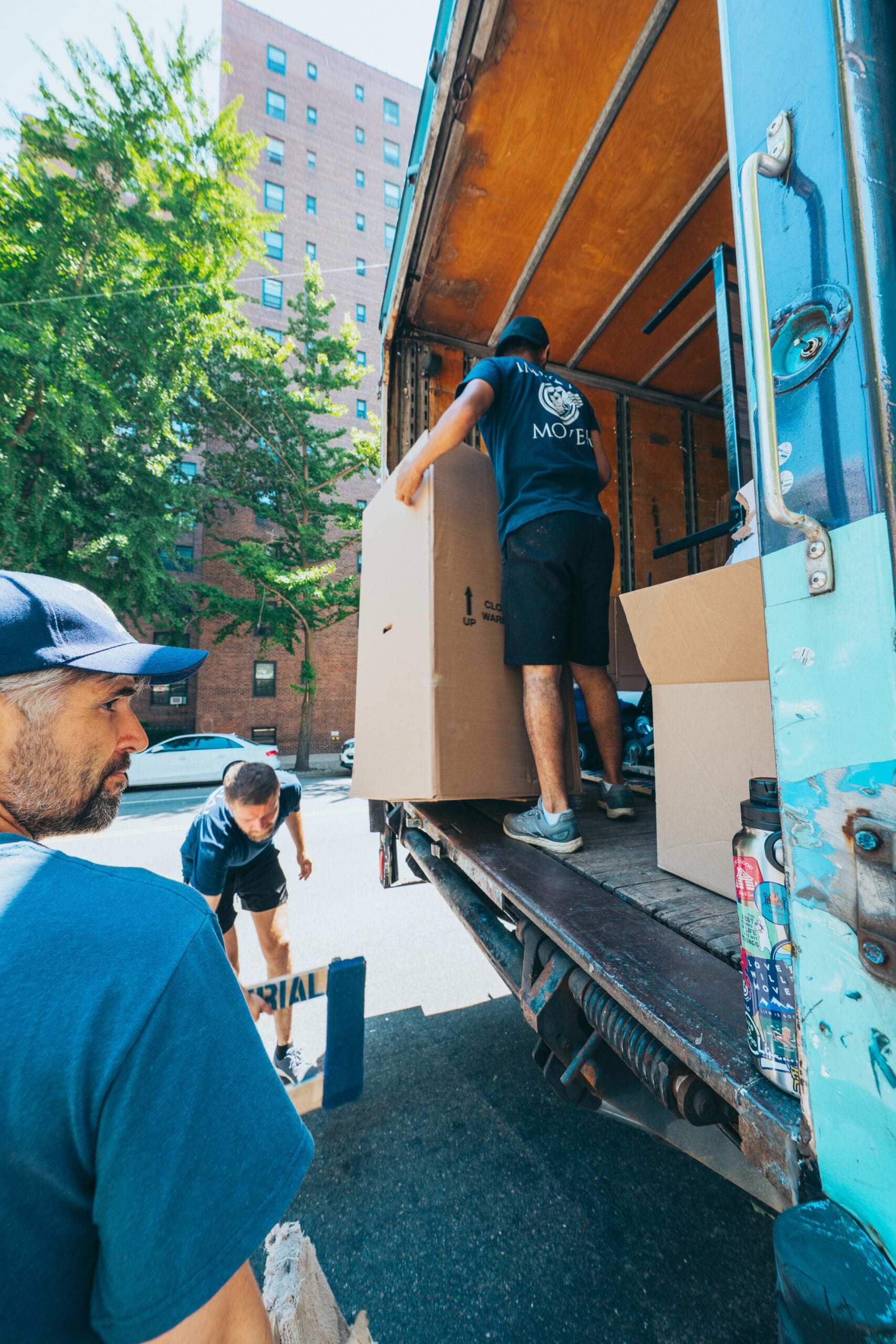Imperial Movers moving box off of truck